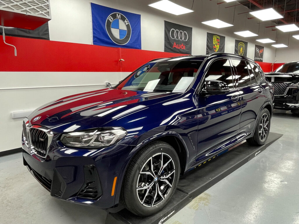 A blue BMW X5 with Performance Clear Bra's Paint Protection Film installation.