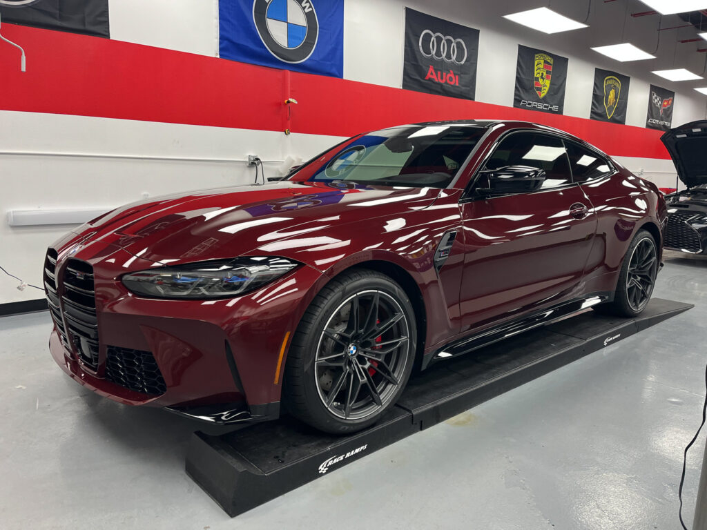 A maroon BMW 4 Series Coupe with Performance Clear Bra's Paint Protection Film installation.