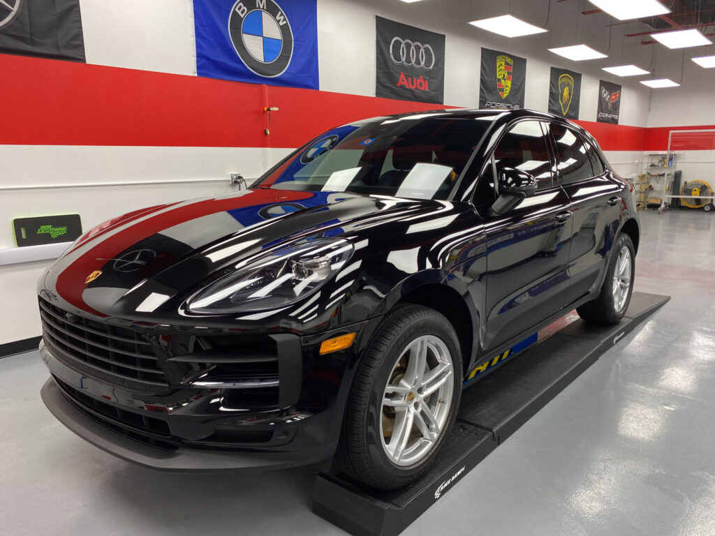 A black Porsche Cayenne with Performance Clear Bra's Paint Protection Film installation.